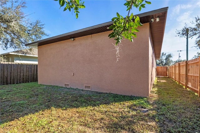 view of property exterior with a lawn