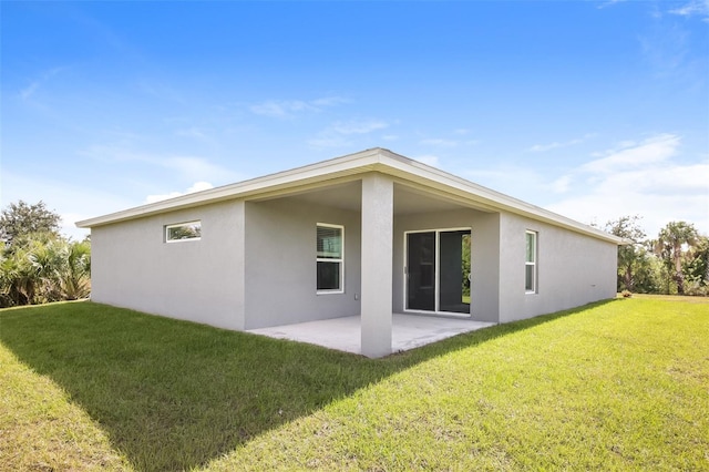 rear view of property featuring a yard and a patio