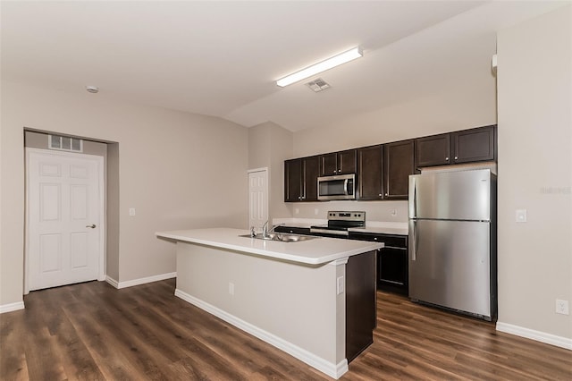 kitchen with lofted ceiling, sink, a kitchen island with sink, dark brown cabinets, and stainless steel appliances