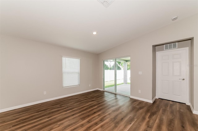 empty room featuring dark hardwood / wood-style flooring and lofted ceiling