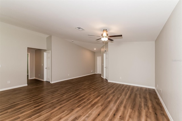 empty room featuring lofted ceiling, dark wood-type flooring, and ceiling fan