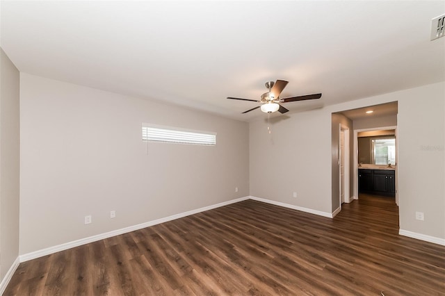 spare room featuring dark hardwood / wood-style floors and ceiling fan