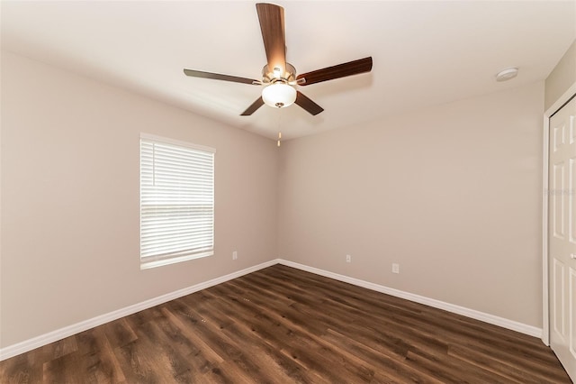 spare room with dark hardwood / wood-style floors and ceiling fan