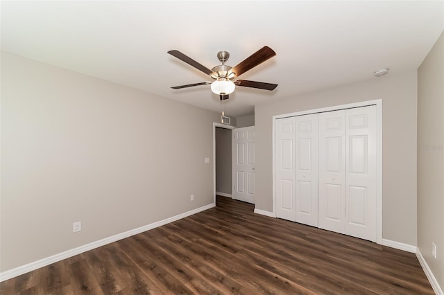 unfurnished bedroom featuring dark hardwood / wood-style floors, a closet, and ceiling fan