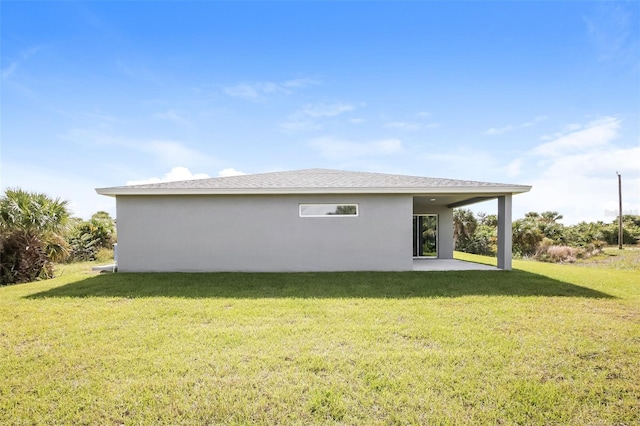 back of property featuring a yard and a patio area