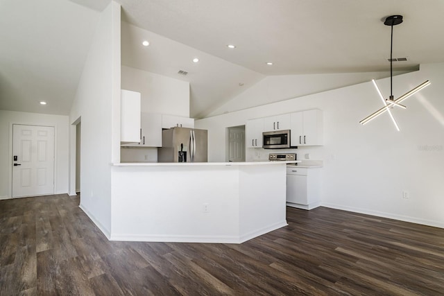 kitchen featuring white cabinetry, high vaulted ceiling, appliances with stainless steel finishes, dark hardwood / wood-style floors, and kitchen peninsula