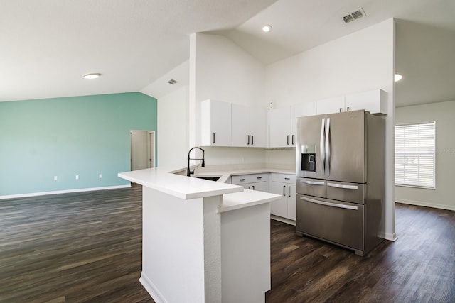 kitchen with white cabinetry, lofted ceiling, sink, and stainless steel fridge with ice dispenser