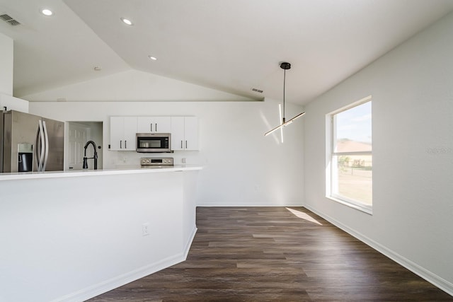 kitchen featuring sink, hanging light fixtures, dark hardwood / wood-style flooring, stainless steel appliances, and white cabinets