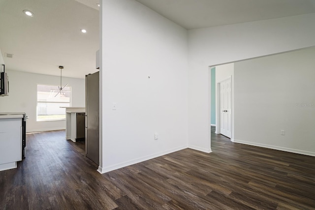 unfurnished room with dark hardwood / wood-style flooring