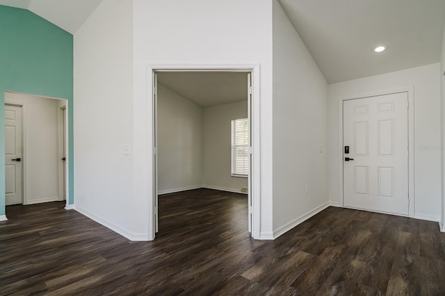 foyer entrance featuring lofted ceiling and dark hardwood / wood-style flooring