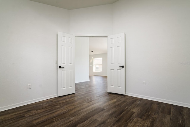 unfurnished room with dark hardwood / wood-style flooring