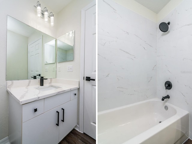 bathroom with tiled shower / bath combo, vanity, and hardwood / wood-style floors