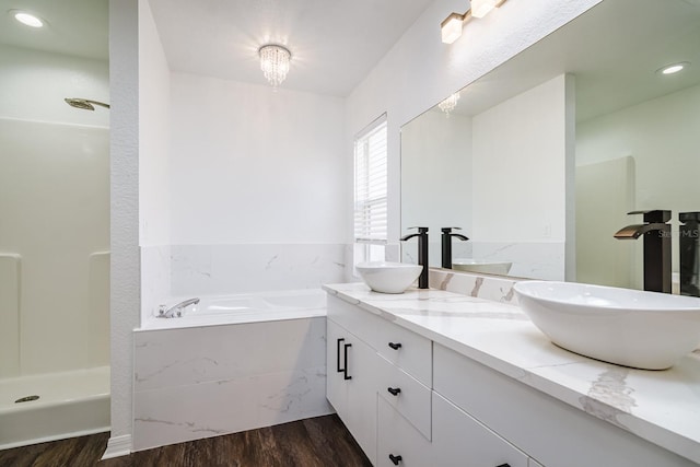 bathroom featuring vanity, shower with separate bathtub, and hardwood / wood-style floors