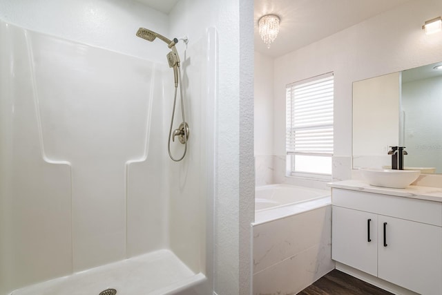 bathroom featuring vanity, plus walk in shower, and hardwood / wood-style floors