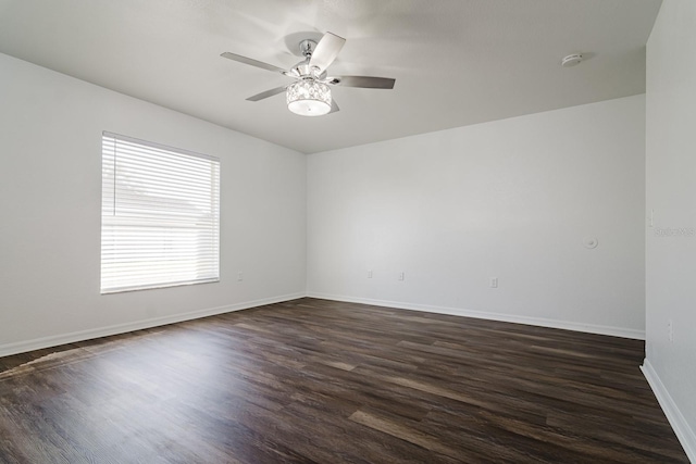 empty room with ceiling fan and dark hardwood / wood-style floors