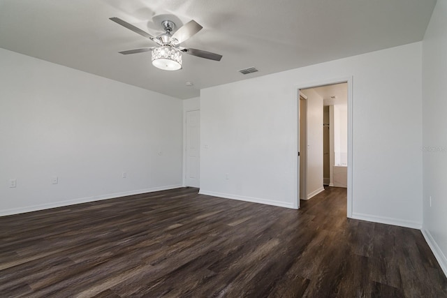 unfurnished room with ceiling fan and dark hardwood / wood-style flooring