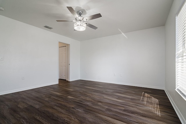 unfurnished room with dark hardwood / wood-style flooring and ceiling fan