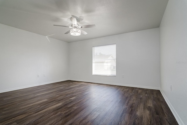 spare room featuring ceiling fan and dark hardwood / wood-style flooring