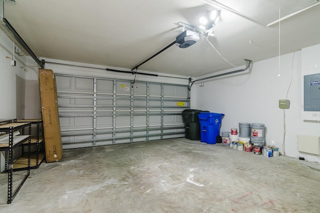 garage with a garage door opener and electric panel