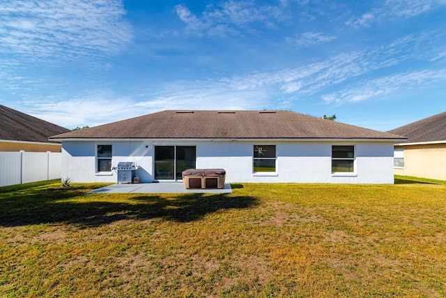 rear view of house featuring a yard and a patio area