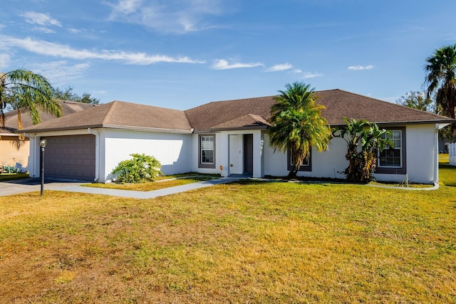 single story home featuring a garage and a front lawn