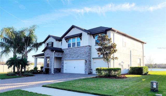 view of front of property featuring a garage, stone siding, a front lawn, and decorative driveway