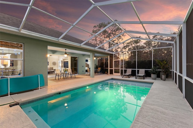 view of swimming pool with a lanai, ceiling fan, and a patio area