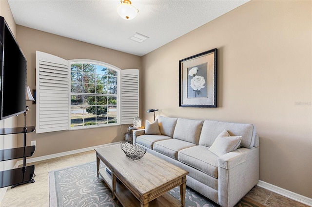 tiled living room with a textured ceiling