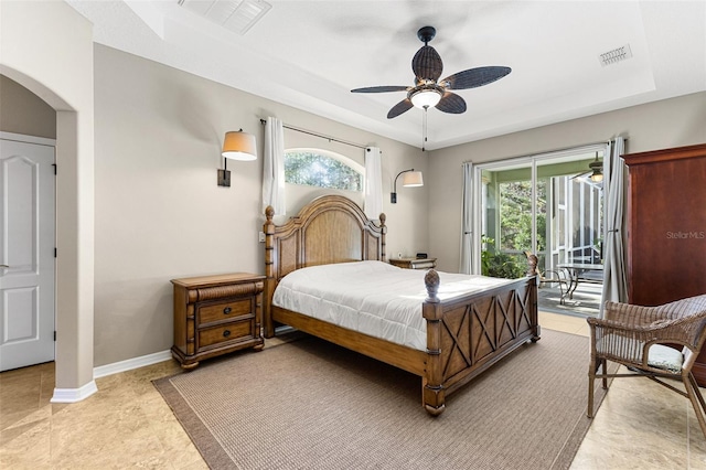 bedroom featuring a raised ceiling, light tile patterned floors, access to exterior, and ceiling fan