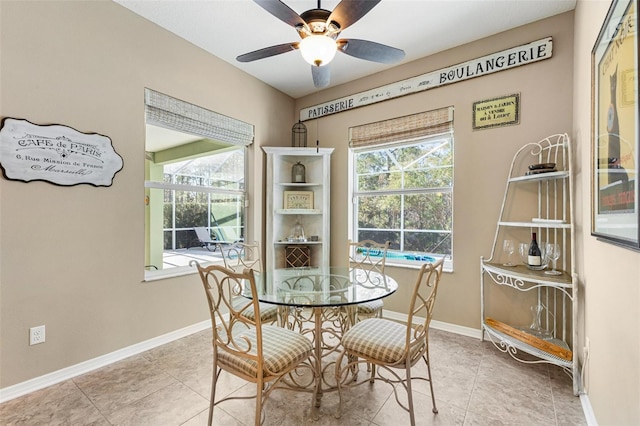 dining room featuring light tile patterned floors, a wealth of natural light, and ceiling fan