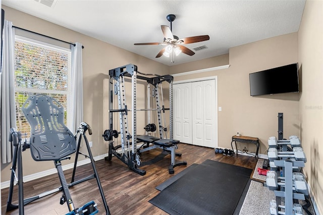 workout area with wood-type flooring and ceiling fan