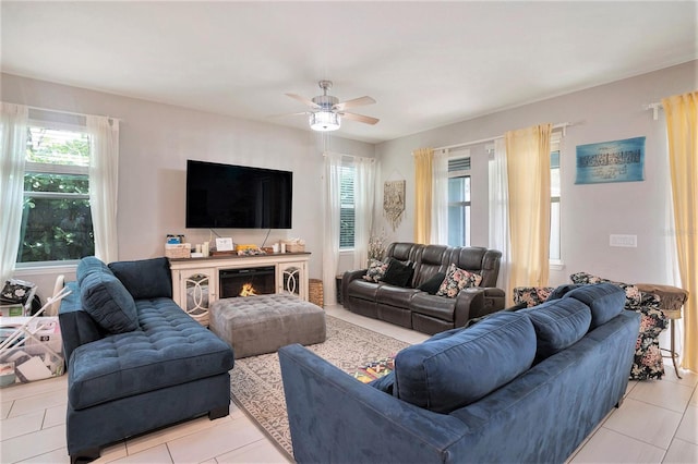 living room with ceiling fan and light tile patterned floors