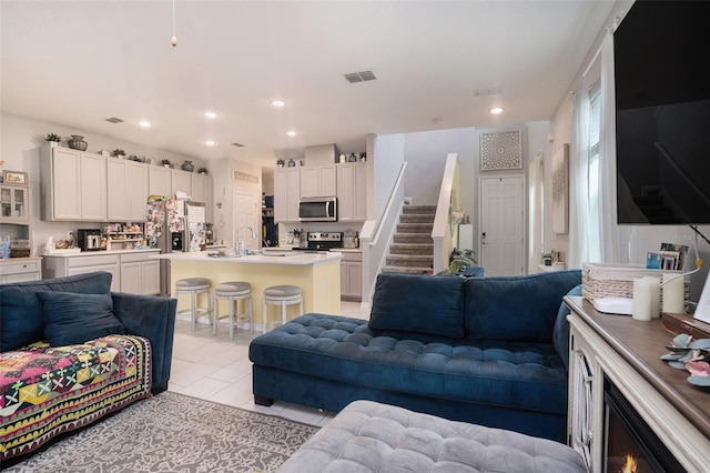 living room with sink and light tile patterned floors