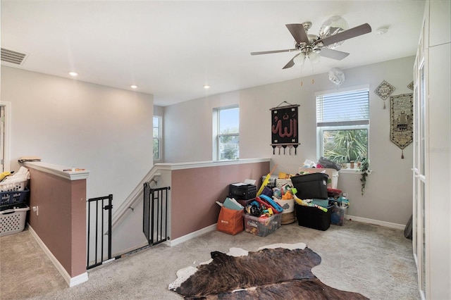 interior space with a wealth of natural light and light colored carpet