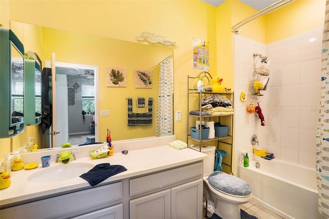 full bathroom featuring vanity, tile patterned floors, toilet, and tiled shower / bath