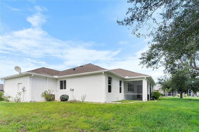 back of property featuring a yard