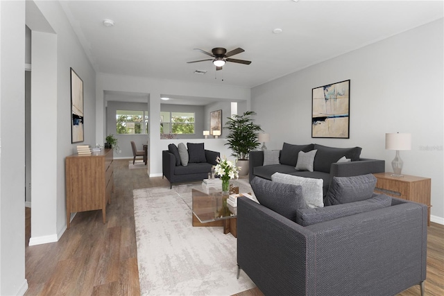 living room featuring hardwood / wood-style flooring and ceiling fan