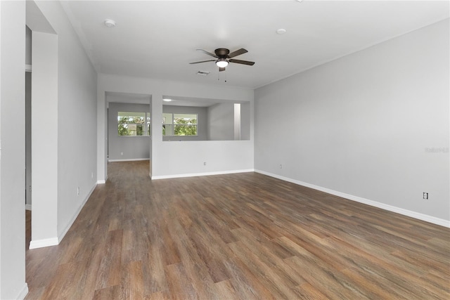 unfurnished room with dark hardwood / wood-style flooring and ceiling fan