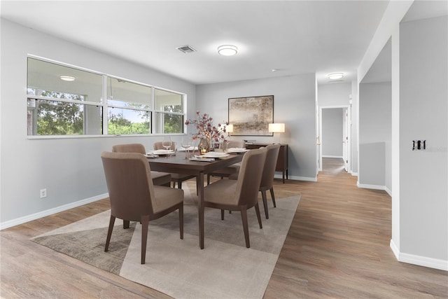 dining space with hardwood / wood-style floors