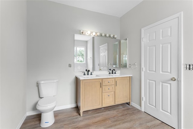 bathroom featuring vanity, hardwood / wood-style floors, and toilet