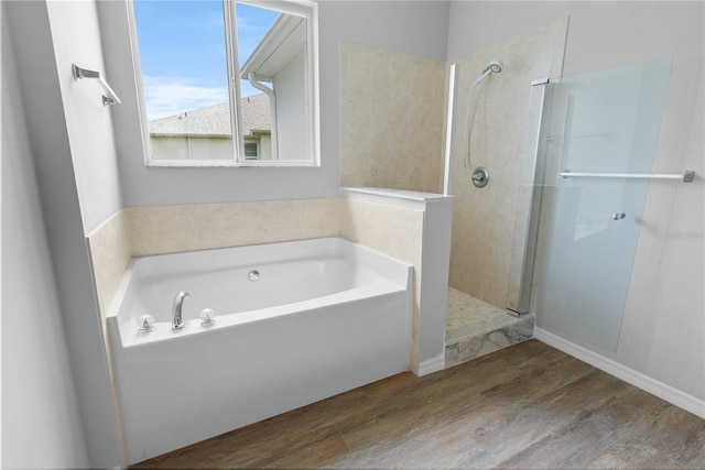 bathroom featuring hardwood / wood-style floors and independent shower and bath