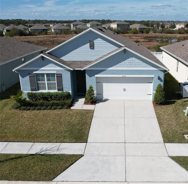 view of front of house featuring a garage, a front yard, and central AC unit