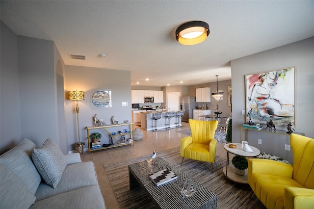 tiled living room with a textured ceiling