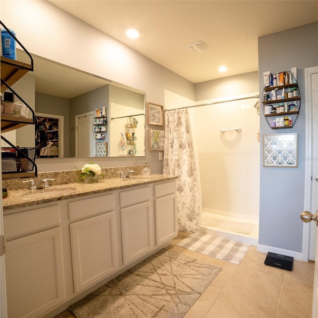 bathroom featuring tile patterned flooring, vanity, and a shower with shower curtain