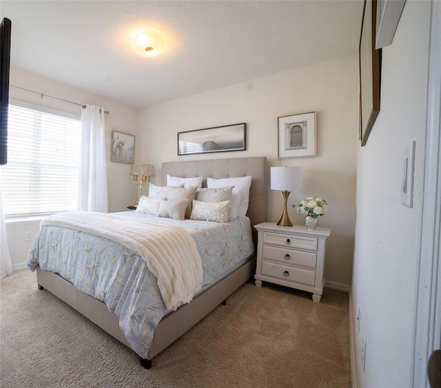 bedroom with light colored carpet