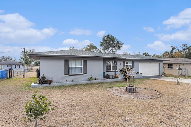 ranch-style house featuring a garage and a front lawn