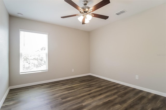 unfurnished room with plenty of natural light, dark hardwood / wood-style floors, and ceiling fan