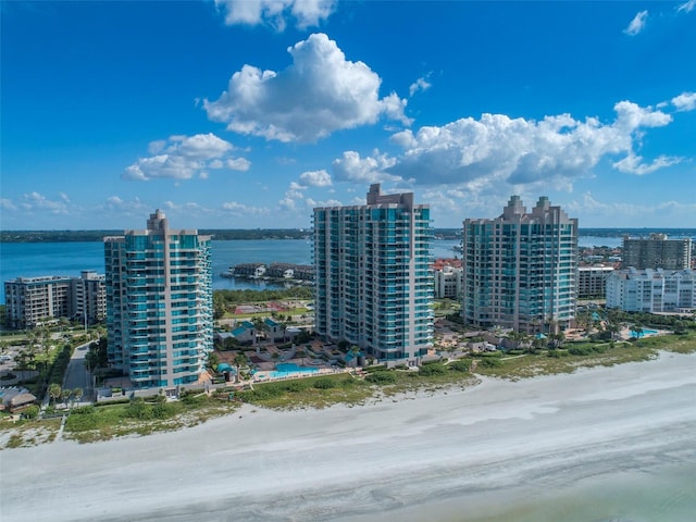 drone / aerial view featuring a water view and a beach view