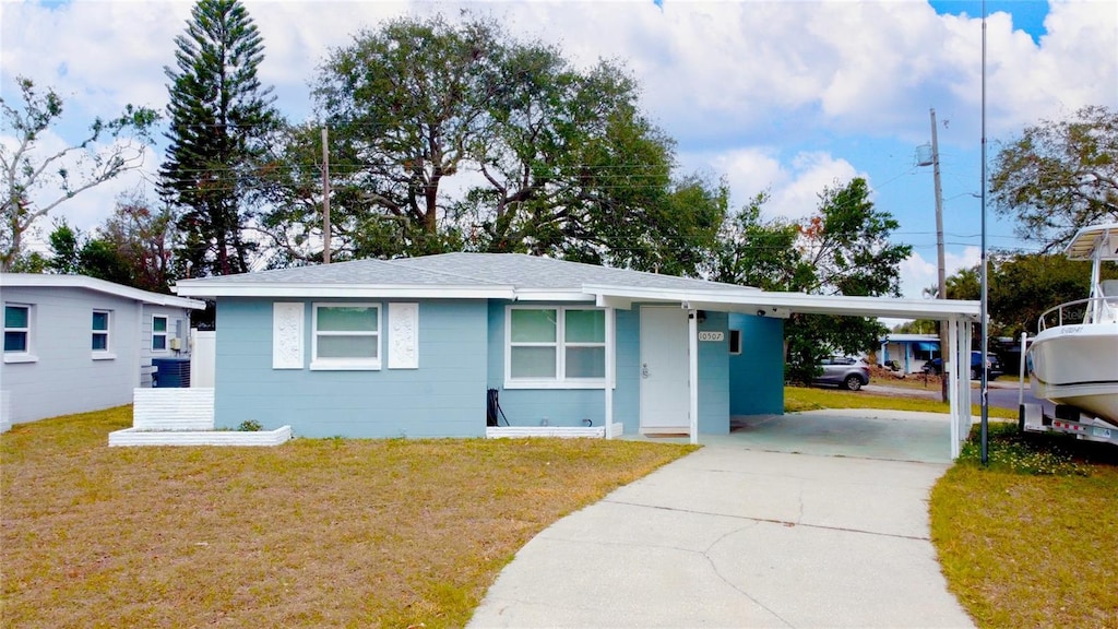 ranch-style home with a carport and a front yard