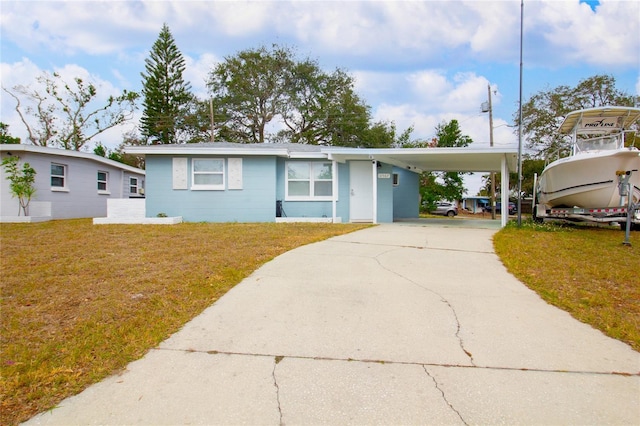 view of front of house featuring a front lawn and a carport